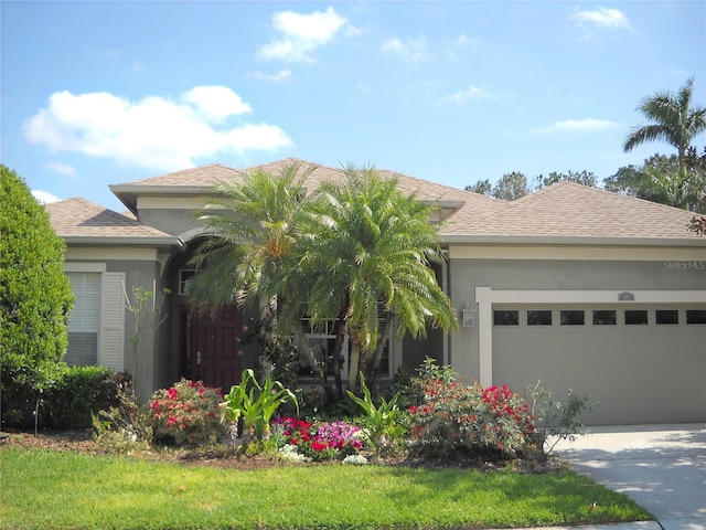 prairie-style home with stucco siding, roof with shingles, concrete driveway, and an attached garage