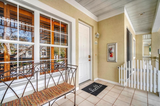 property entrance featuring covered porch and stucco siding