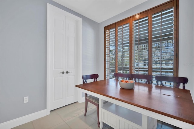 dining area with tile patterned flooring and baseboards