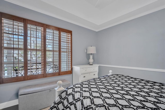 bedroom with baseboards, multiple windows, and ornamental molding