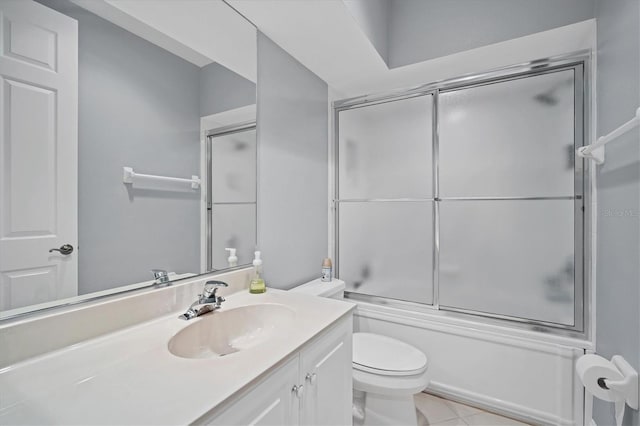 bathroom with tile patterned flooring, toilet, vanity, and shower / bath combination with glass door