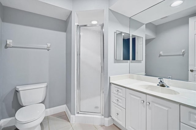 full bath with baseboards, toilet, a stall shower, tile patterned floors, and vanity