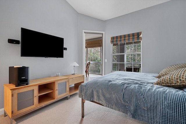 bedroom with light colored carpet and access to outside