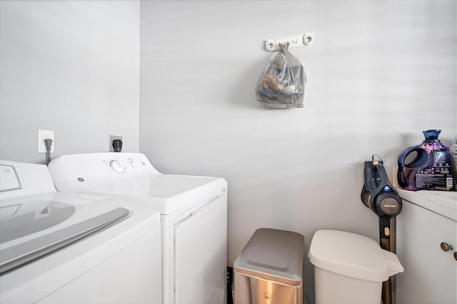 clothes washing area featuring laundry area and washing machine and clothes dryer