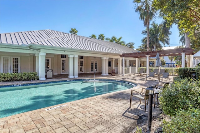 community pool featuring a patio area, fence, french doors, and a pergola