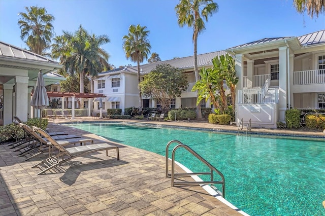 pool featuring a patio and a pergola