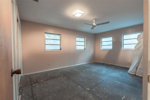 unfurnished room featuring baseboards and ceiling fan