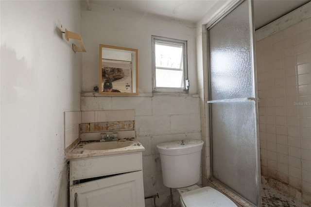 bathroom with vanity, a shower stall, and toilet