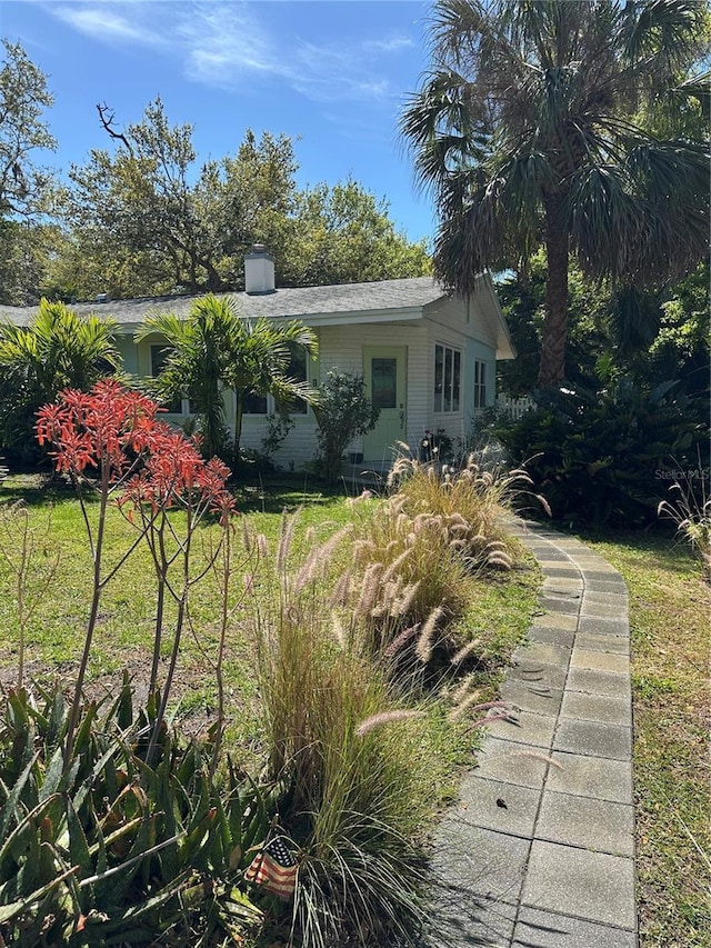 back of property with a chimney