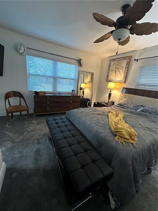 carpeted bedroom with baseboards and a ceiling fan