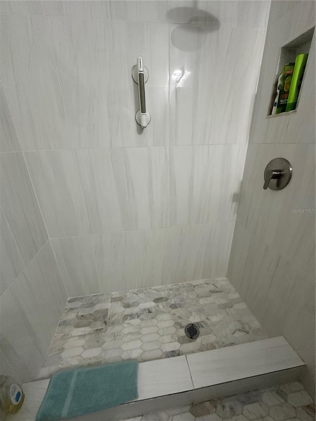 full bath with a tile shower