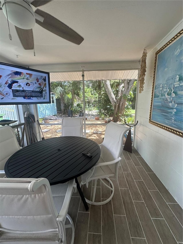 728 41st St, Sarasota, FL 34234 - sunroom with wood finished floors, a ceiling fan, and outdoor dining area
