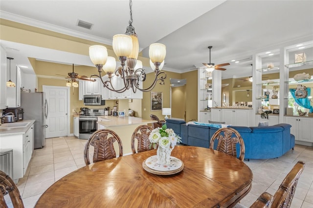 dining room featuring light tile patterned floors, visible vents, ornamental molding, and ceiling fan with notable chandelier