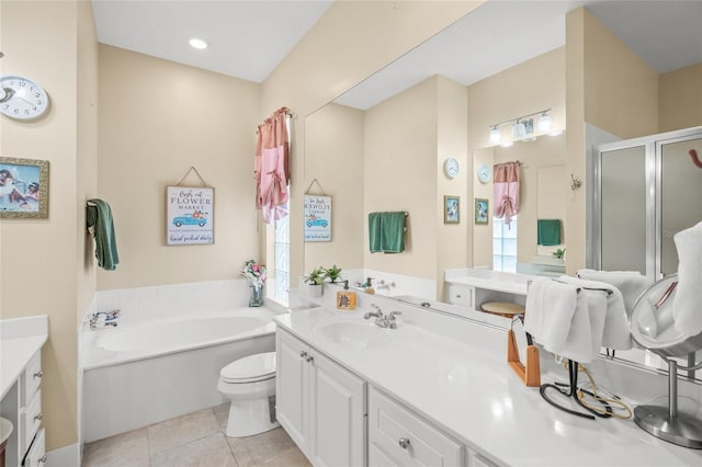 bathroom featuring tile patterned floors, vanity, a bath, and a shower stall