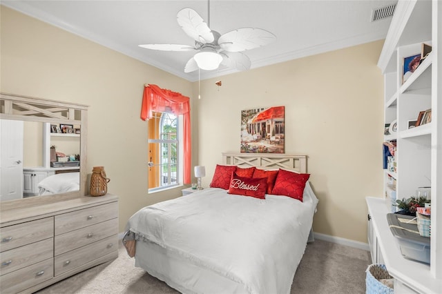 bedroom featuring visible vents, baseboards, ceiling fan, ornamental molding, and carpet flooring