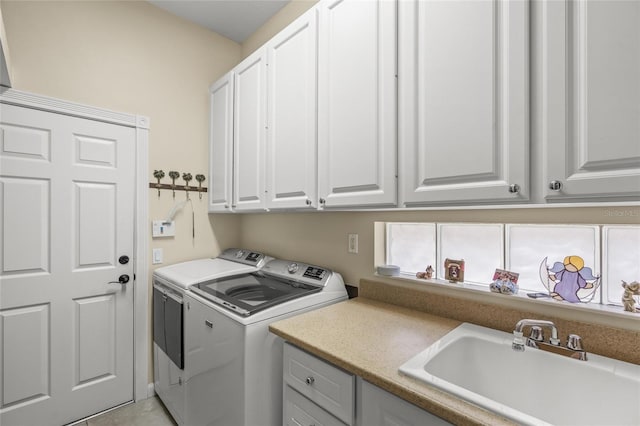 laundry area with a sink, cabinet space, and washer and clothes dryer