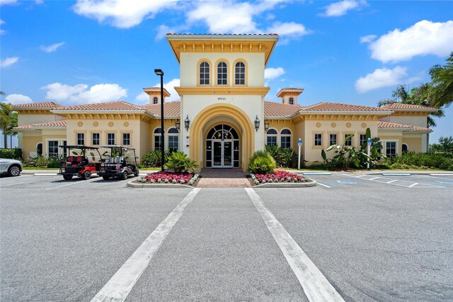 view of building exterior with uncovered parking