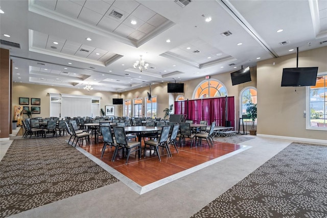 dining area with visible vents, a towering ceiling, and crown molding