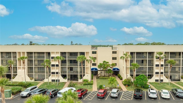 view of building exterior with uncovered parking