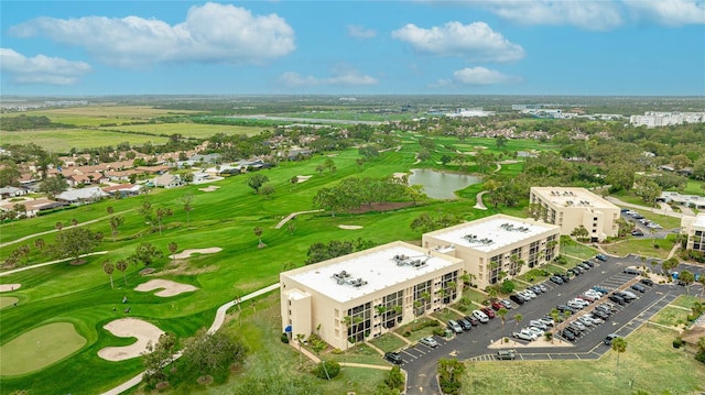 birds eye view of property with a water view and golf course view