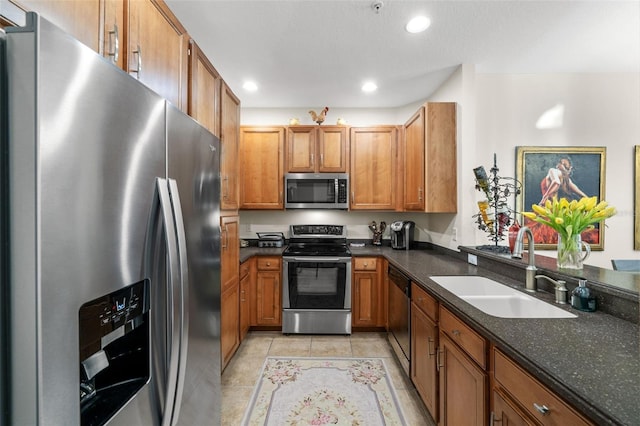 kitchen featuring a sink, stainless steel appliances, brown cabinets, and recessed lighting