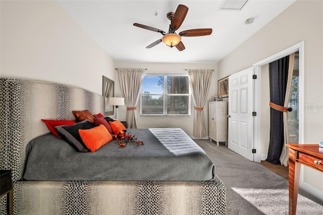 carpeted bedroom with visible vents and ceiling fan