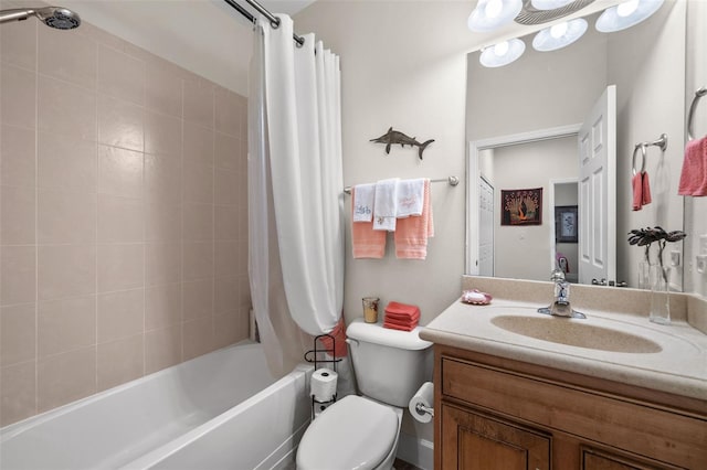 bathroom featuring vanity, toilet, and shower / bath combo with shower curtain