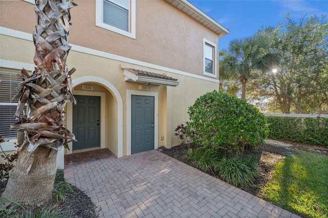 property entrance with stucco siding