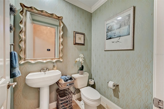 bathroom featuring toilet, crown molding, and wallpapered walls