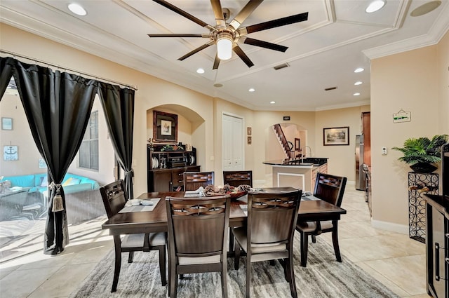 dining space with baseboards, visible vents, recessed lighting, arched walkways, and ornamental molding