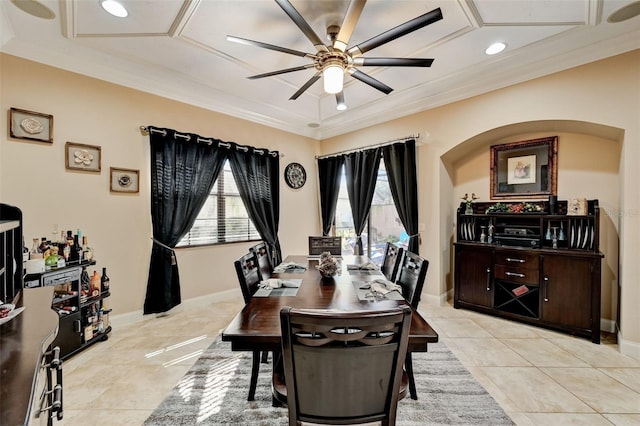 dining space featuring light tile patterned flooring, baseboards, a ceiling fan, and ornamental molding