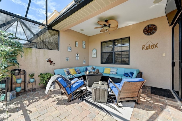 view of patio / terrace featuring glass enclosure, outdoor lounge area, and ceiling fan