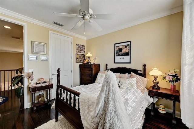 bedroom with visible vents, crown molding, baseboards, a ceiling fan, and dark wood-style flooring