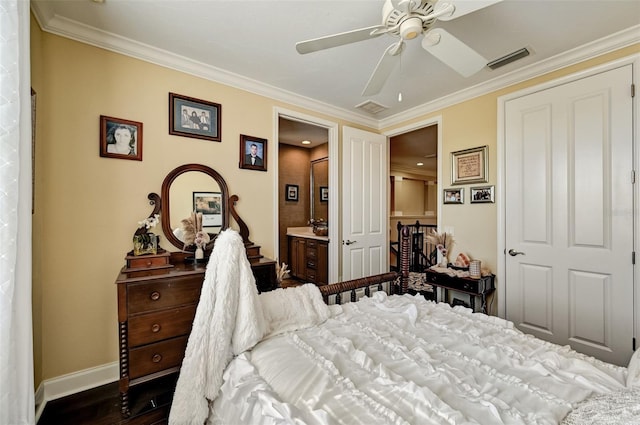 bedroom featuring visible vents, baseboards, dark wood finished floors, and crown molding