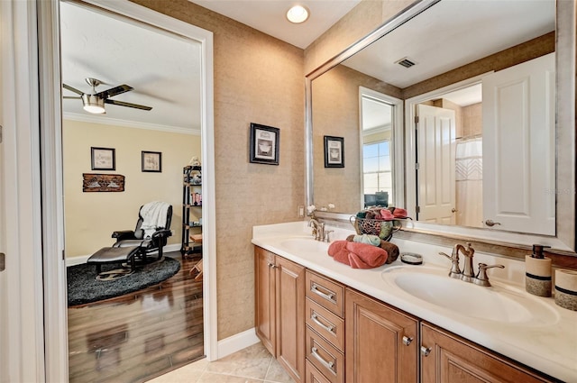 bathroom with a sink, visible vents, double vanity, and tile patterned floors