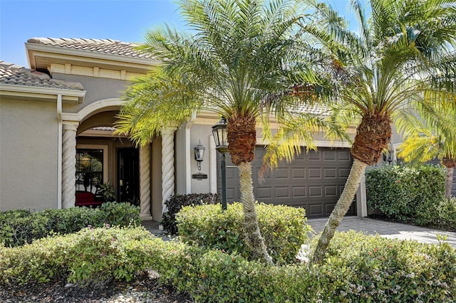 entrance to property with stucco siding and a tiled roof