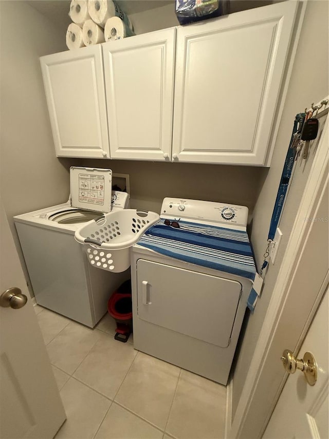 laundry room featuring light tile patterned flooring, cabinet space, and hookup for a washing machine