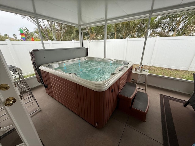 sunroom with a jacuzzi and plenty of natural light