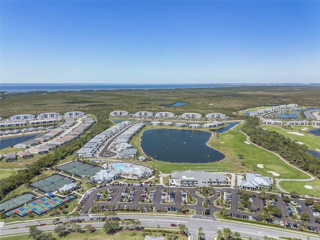 aerial view with golf course view and a water view