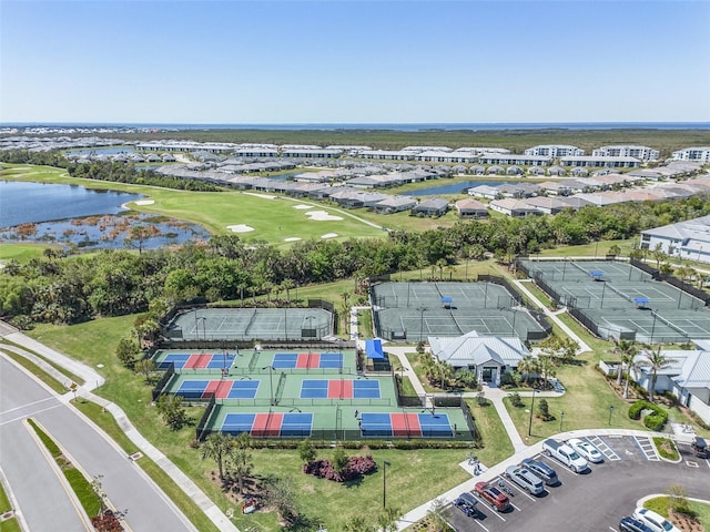 birds eye view of property with a water view and view of golf course