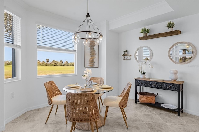 dining area with baseboards, an inviting chandelier, and crown molding