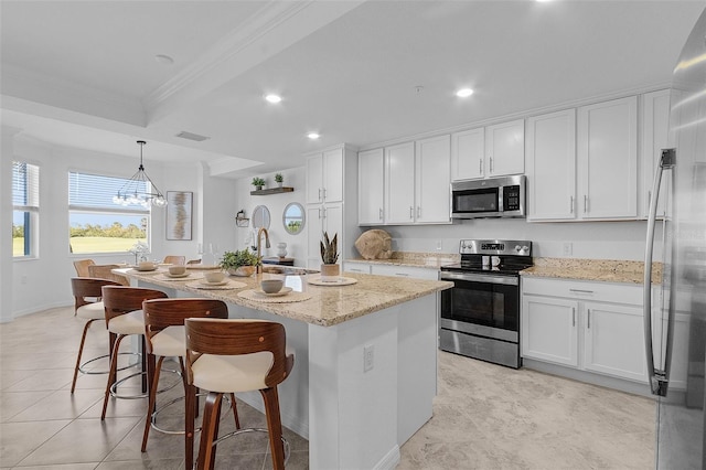 kitchen featuring a sink, appliances with stainless steel finishes, ornamental molding, and white cabinetry