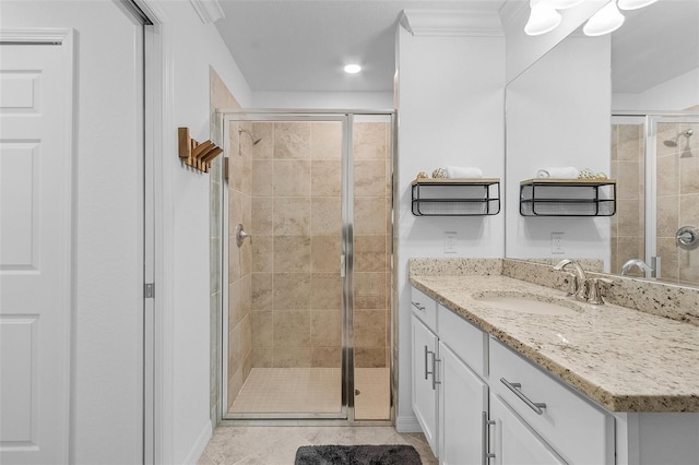 full bath featuring tile patterned floors, a stall shower, and vanity