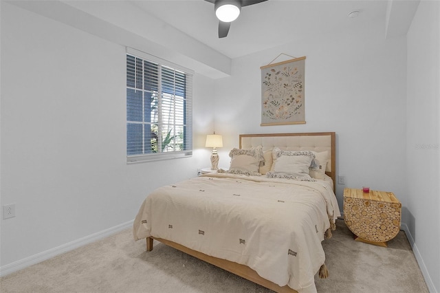 carpeted bedroom featuring a ceiling fan and baseboards