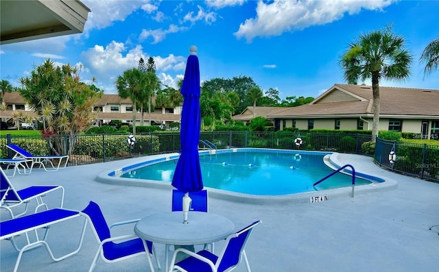 pool featuring a patio area and fence