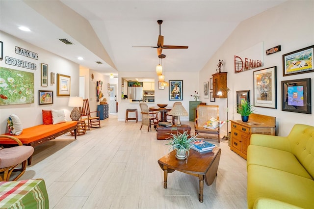 living area with light wood-type flooring, visible vents, recessed lighting, and vaulted ceiling