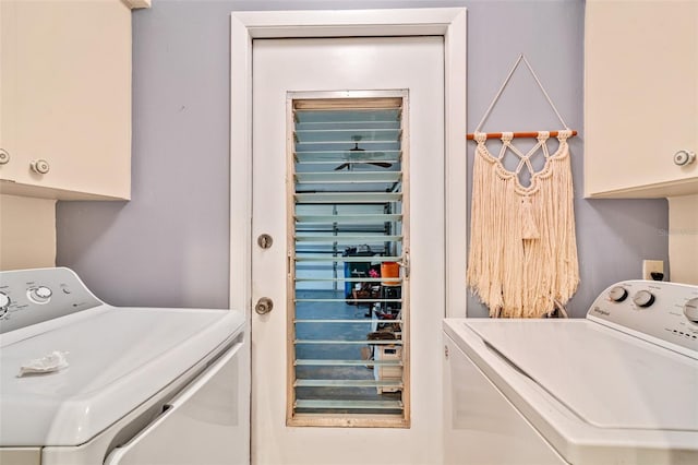 clothes washing area with cabinet space and washer and clothes dryer