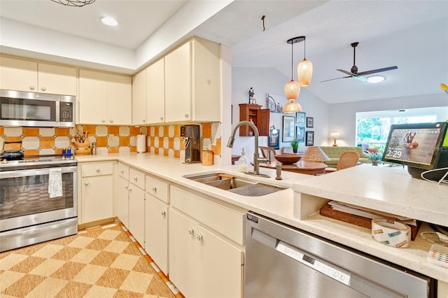 kitchen featuring light floors, a sink, stainless steel appliances, light countertops, and tasteful backsplash