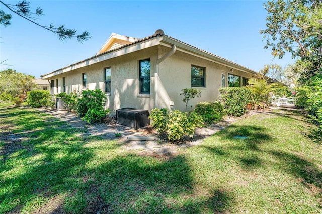 view of property exterior with a yard and stucco siding