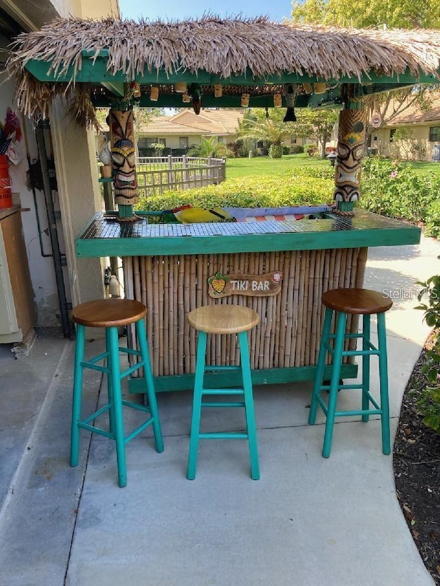 bar with a bar and unfinished concrete flooring